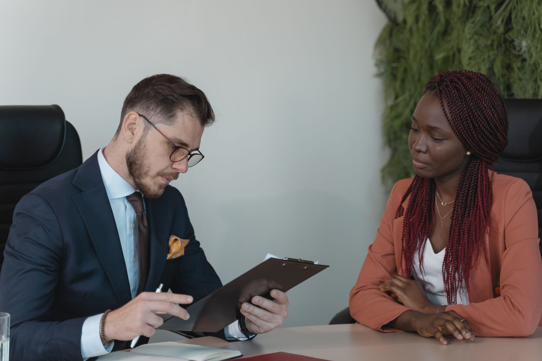 A man and woman engaging in a job interview in a modern office setting — UPI Study