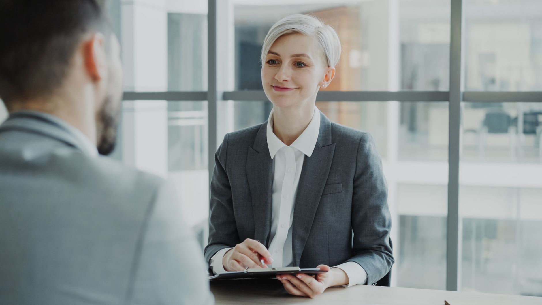 Confident woman interviewing candidate in a modern office. Ideal for business and HR visuals — UPI Study