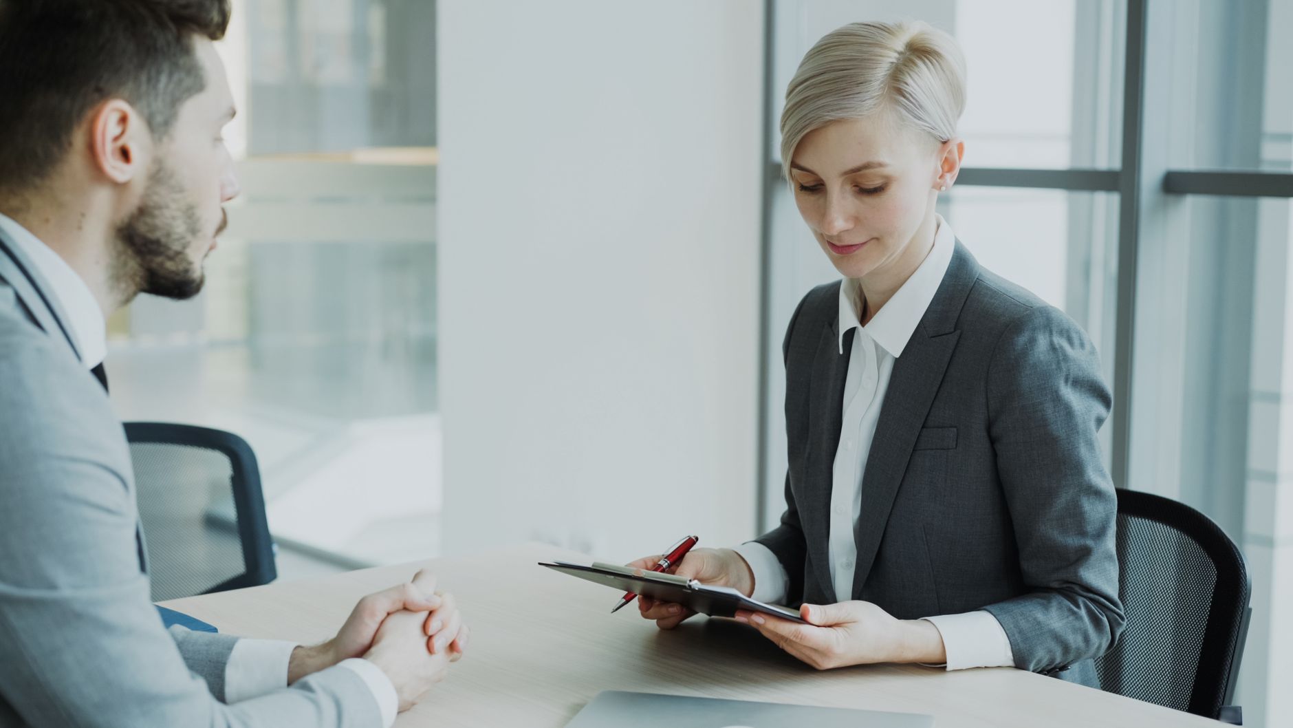 Two professionals in a modern office discussing business. Bright, professional setting — UPI Study