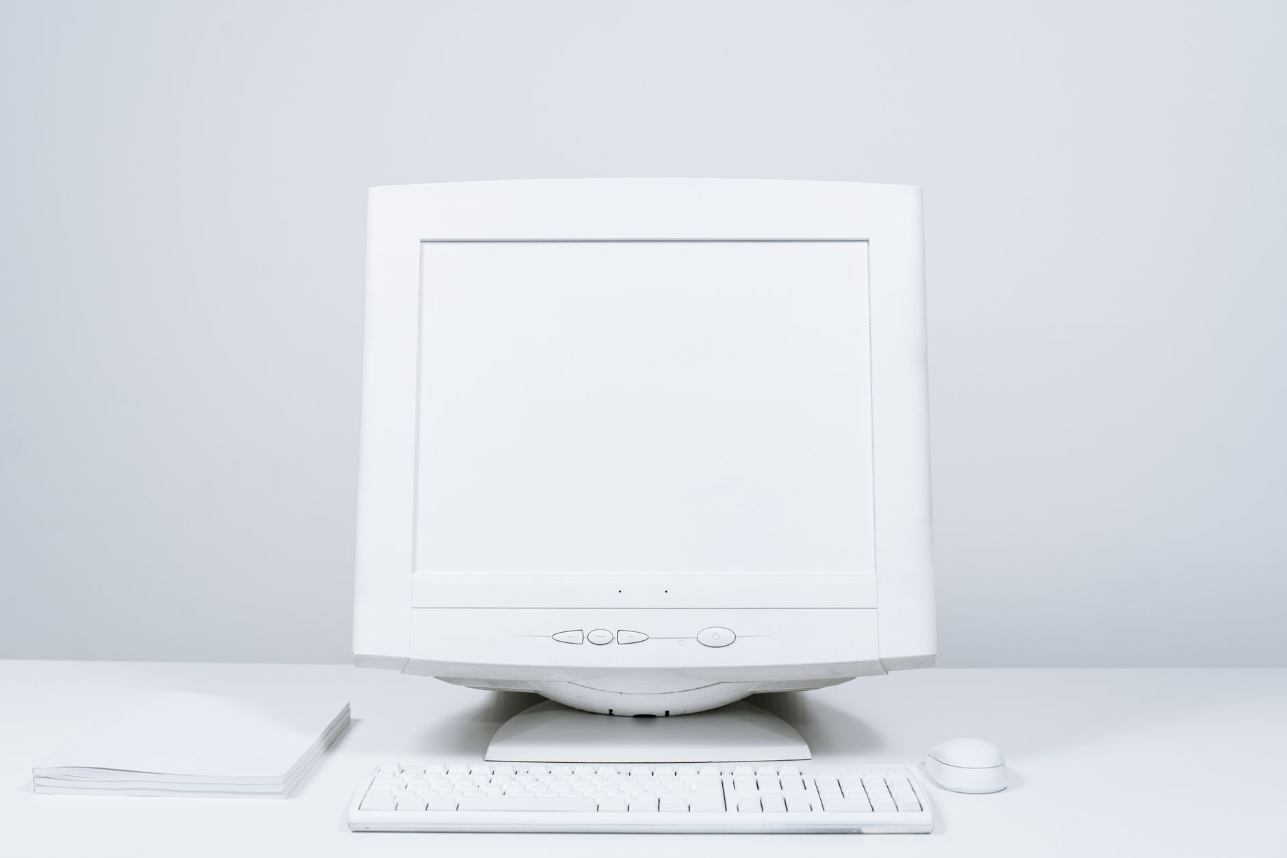 A minimalist white computer setup including monitor, keyboard, and mouse on desktop — UPI Study