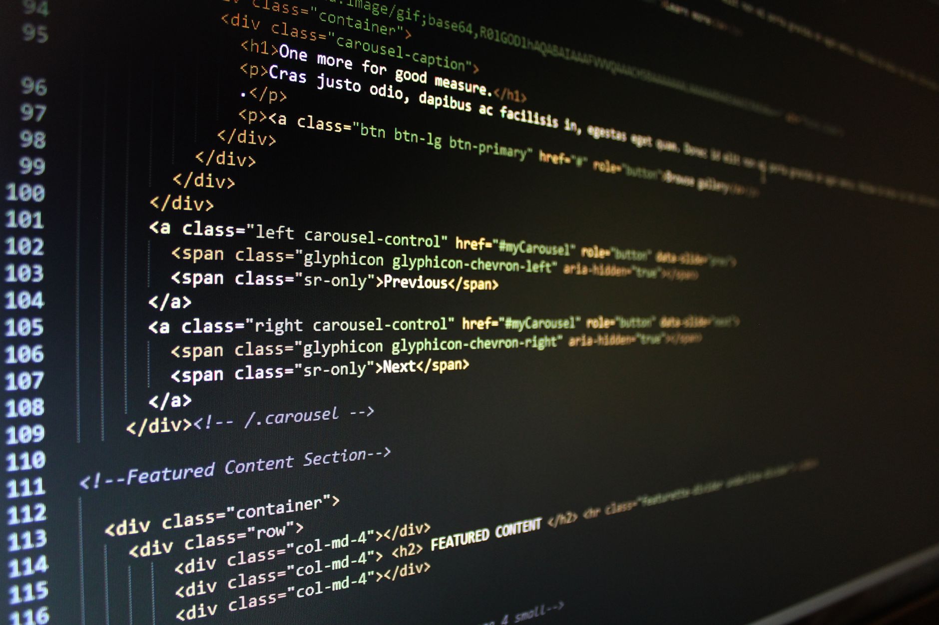 Close-up of HTML code displayed on a computer monitor, showcasing web development — UPI Study