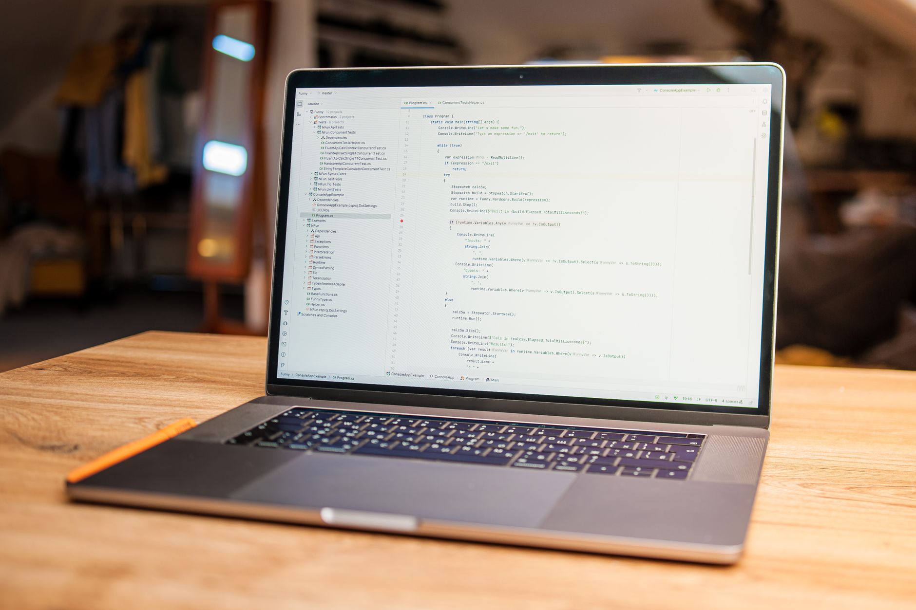 Open laptop with visible code on screen on a wooden desk in a modern, cozy workspace — UPI Study