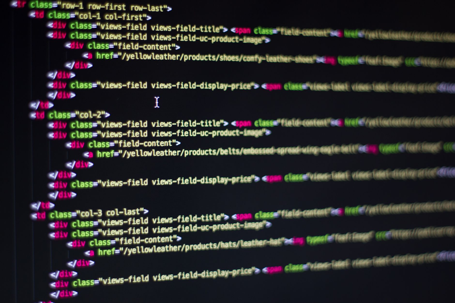 Detailed close-up of HTML code on a computer monitor, showcasing web development — UPI Study