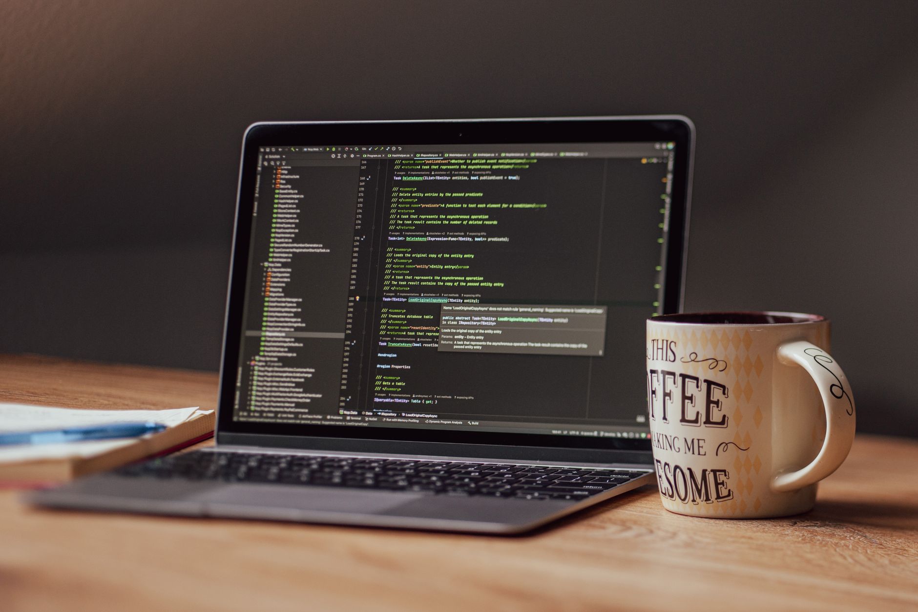 Laptop displaying code editor with coffee mug on desk, perfect for tech themes — UPI Study