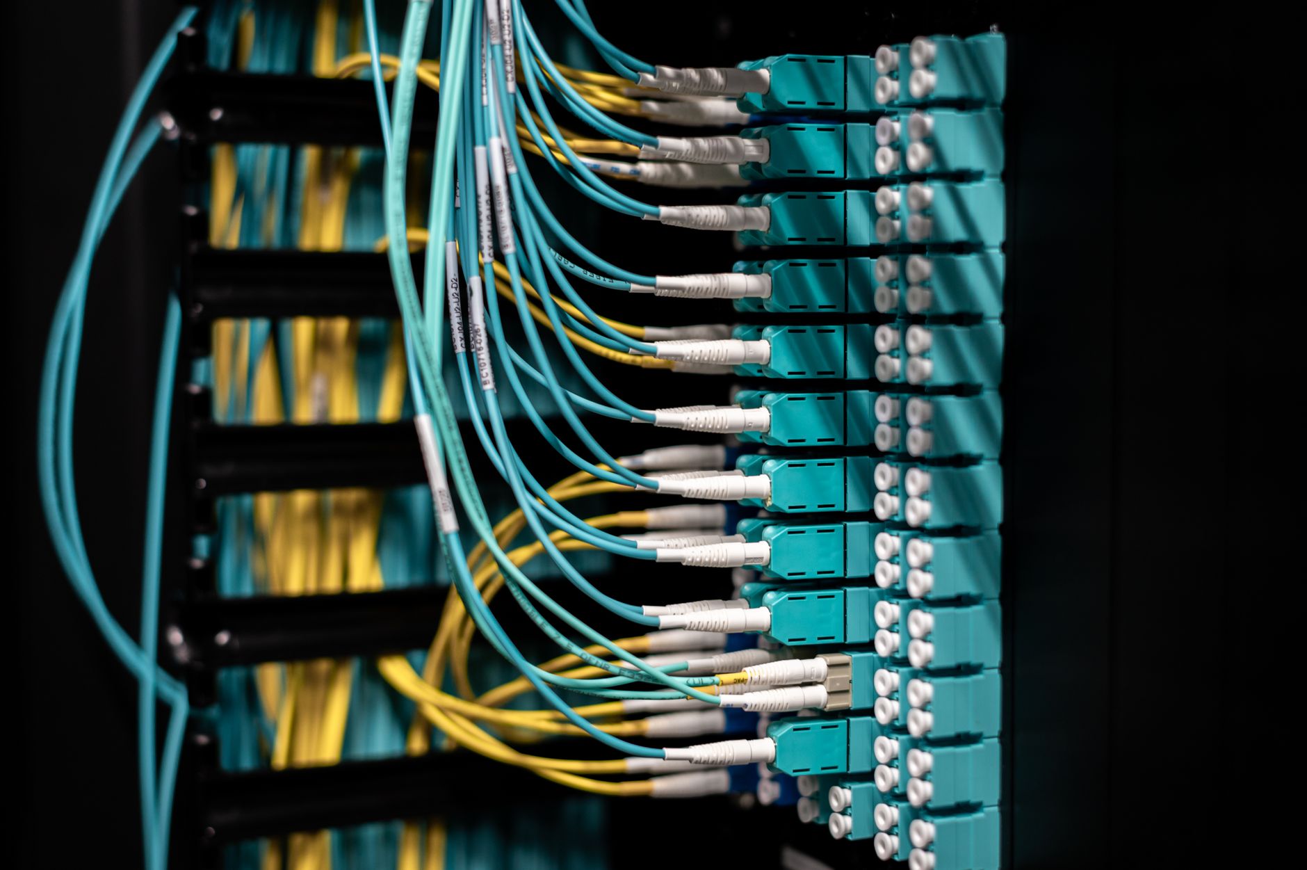 Closeup of switch in server with connectors and adapters connected to plastic device in dark room on blurred background inside — UPI Study