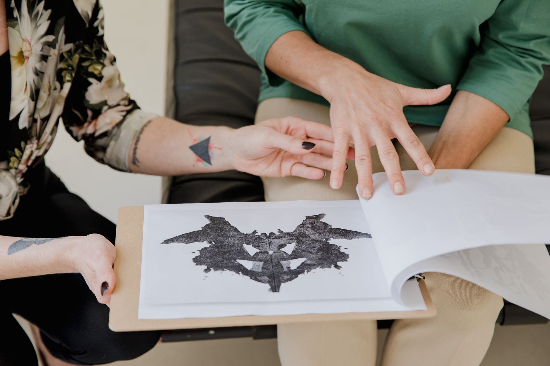 Close-up of two women discussing a Rorschach inkblot test during a therapy session — UPI Study