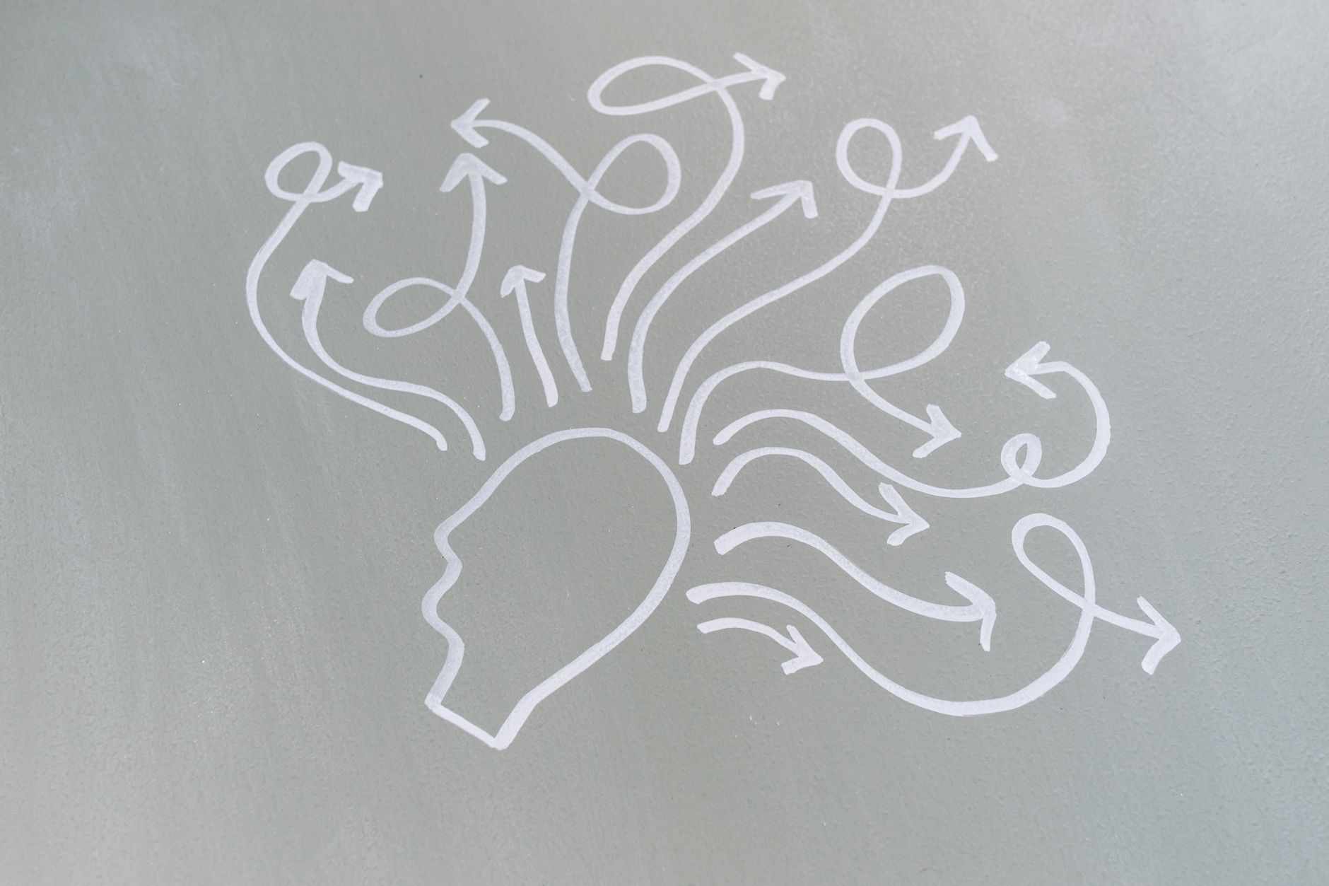Chalk drawing of a head with swirling arrows represents mental activity and thought process — UPI Study