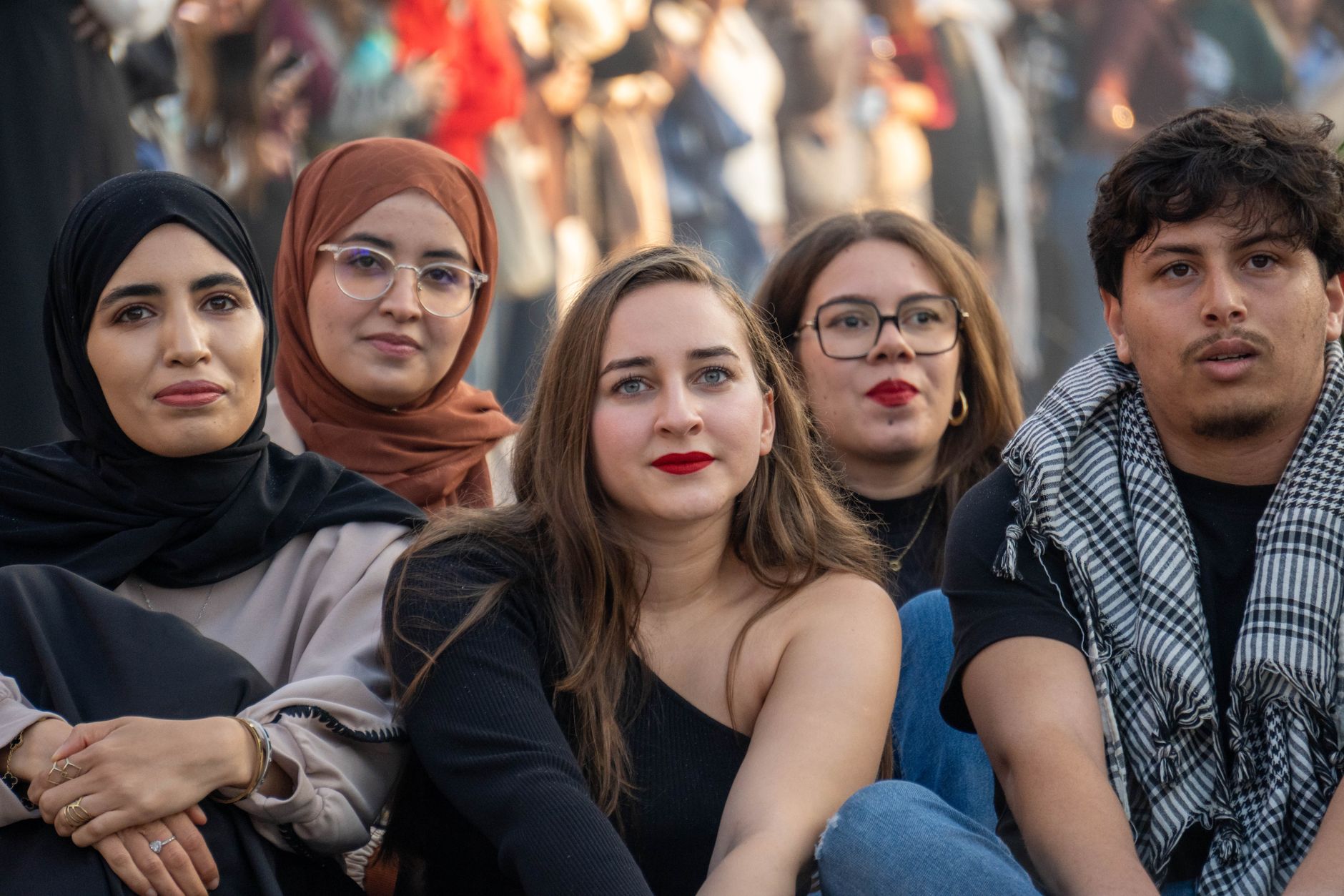 A diverse group of young adults sitting at an outdoor gathering, showcasing cultural diversity and friendship — UPI Study