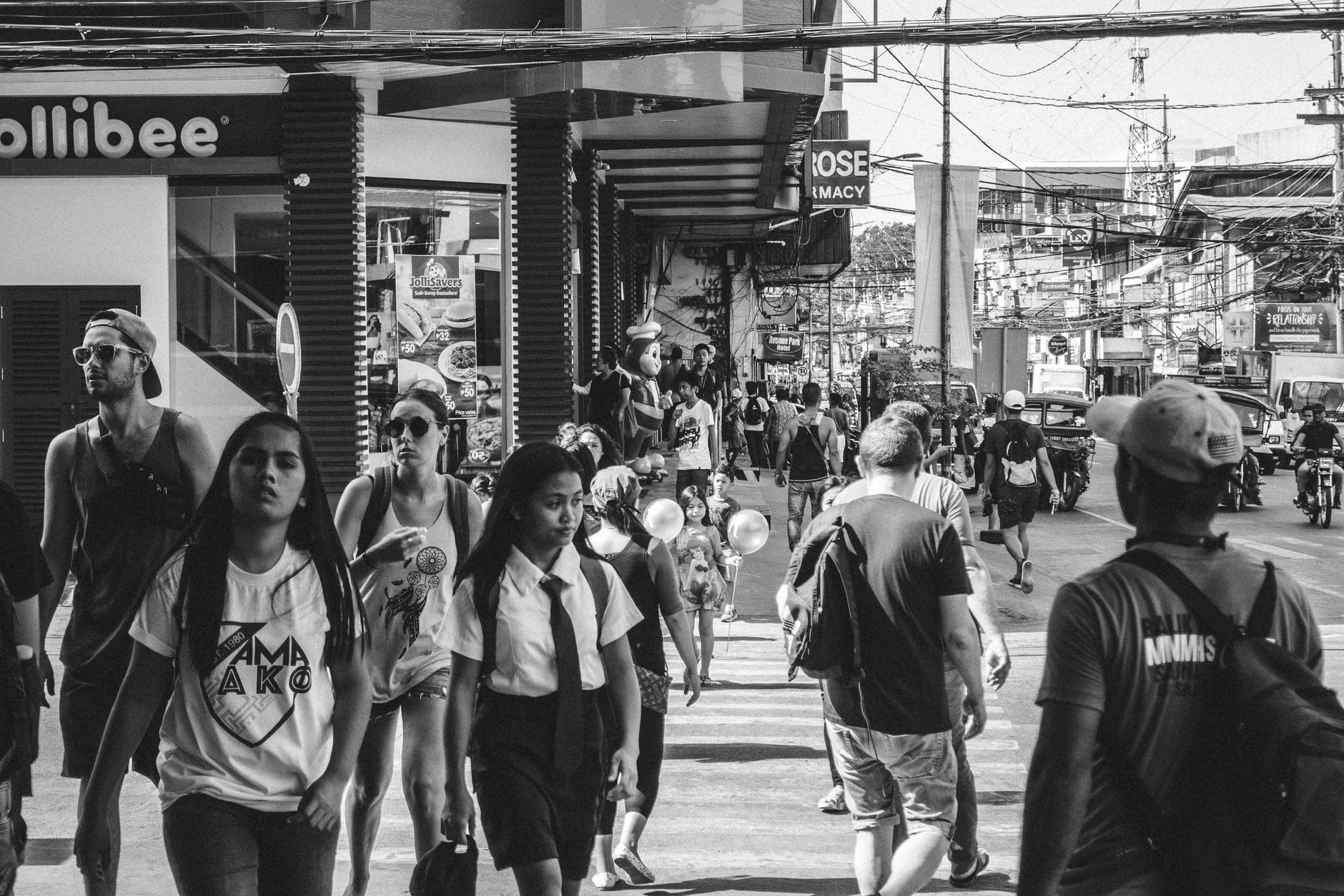Black and white busy street scene in Dumaguete, featuring diverse pedestrians and urban life — UPI Study