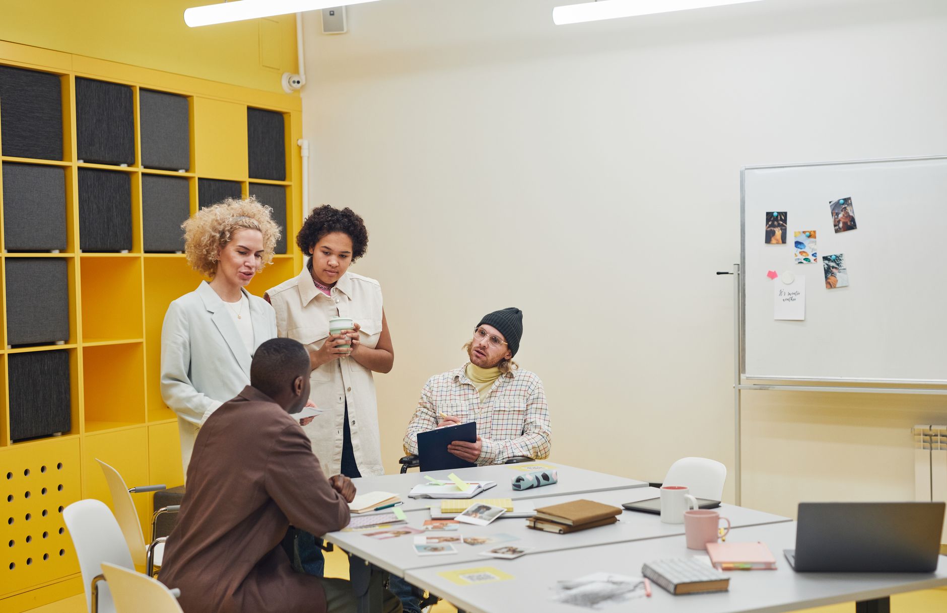 A diverse group of professionals having a collaborative meeting in a modern office space — UPI Study