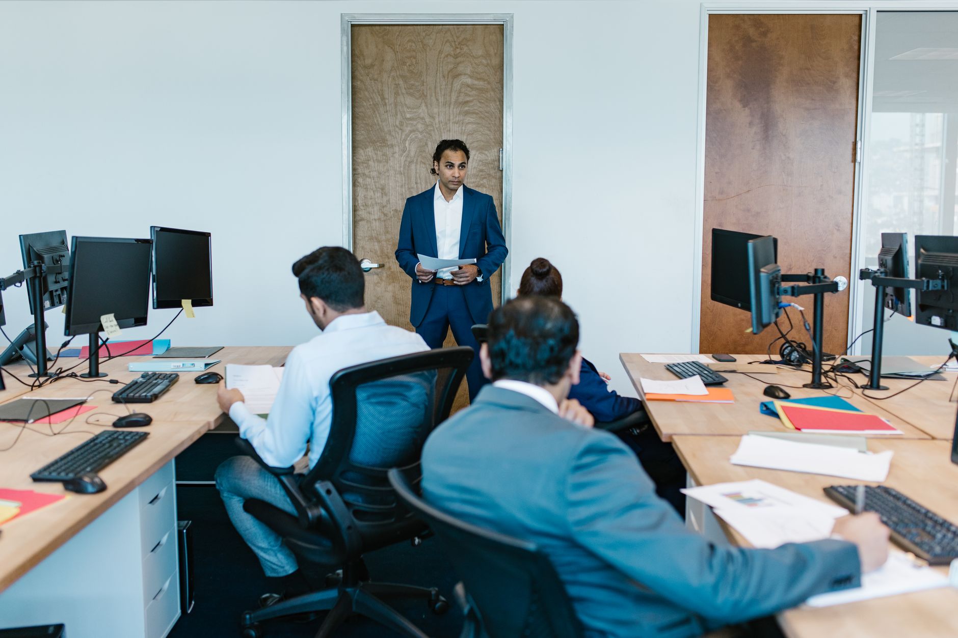 Business meeting with diverse team in modern office space, discussing projects — UPI Study
