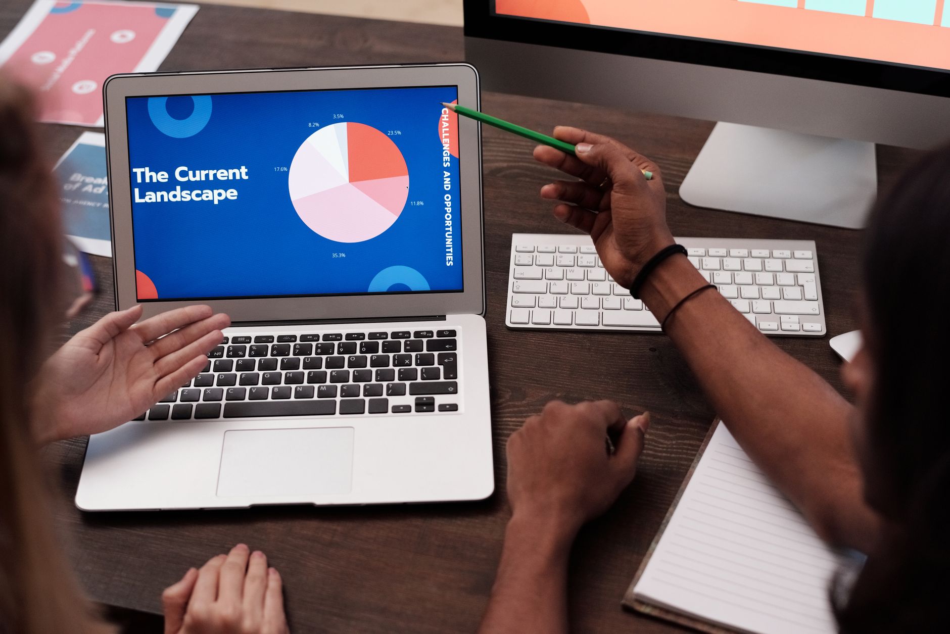 Team discussing data with graph on laptop screen in office setting — UPI Study