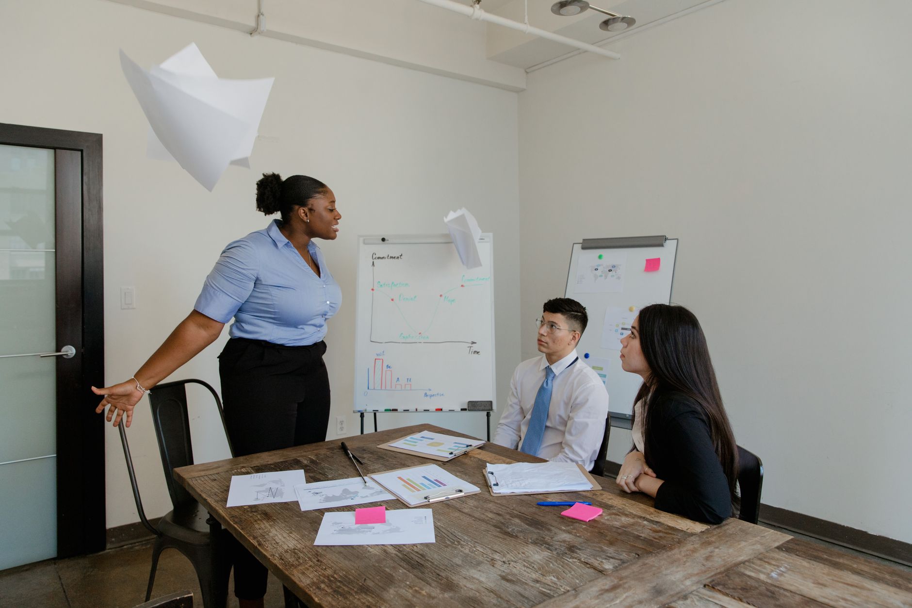 A group of colleagues engaged in a lively discussion in a modern office setting, emphasizing teamwork and collaboration — UPI Study