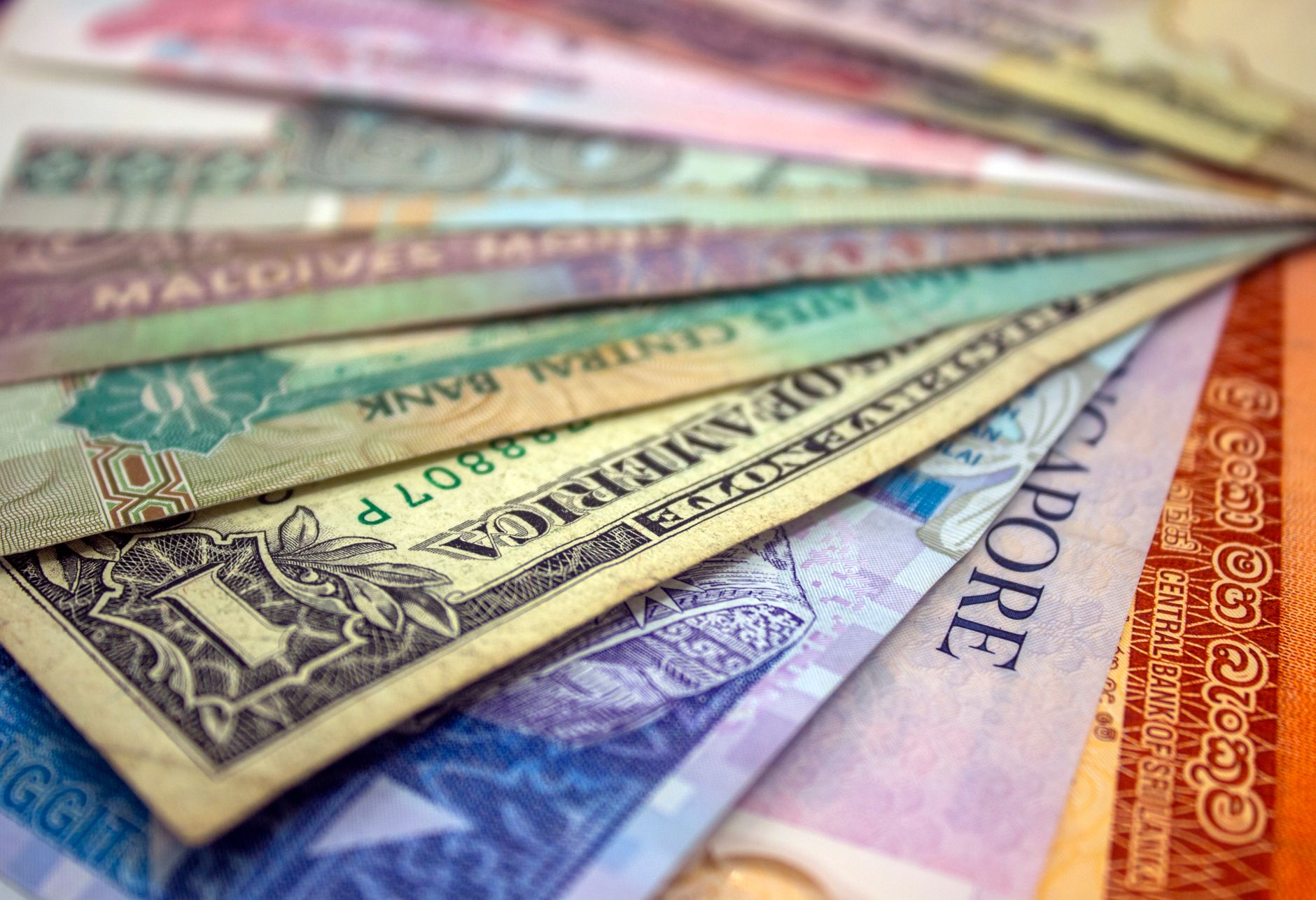 A close-up view of various international banknotes showcasing diverse currencies — UPI Study