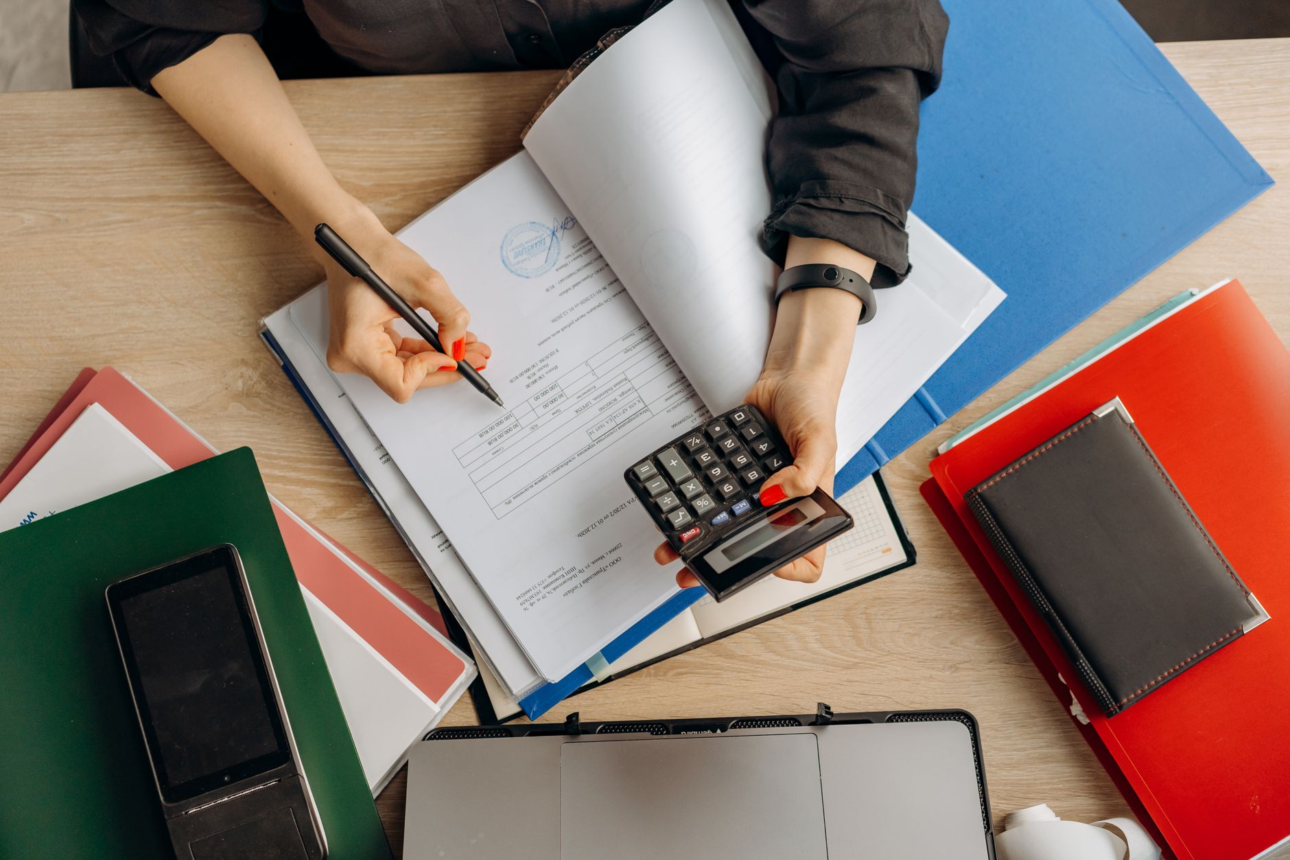 Accountant analyzing financial documents with a calculator on a desk, highlighting business tasks — UPI Study