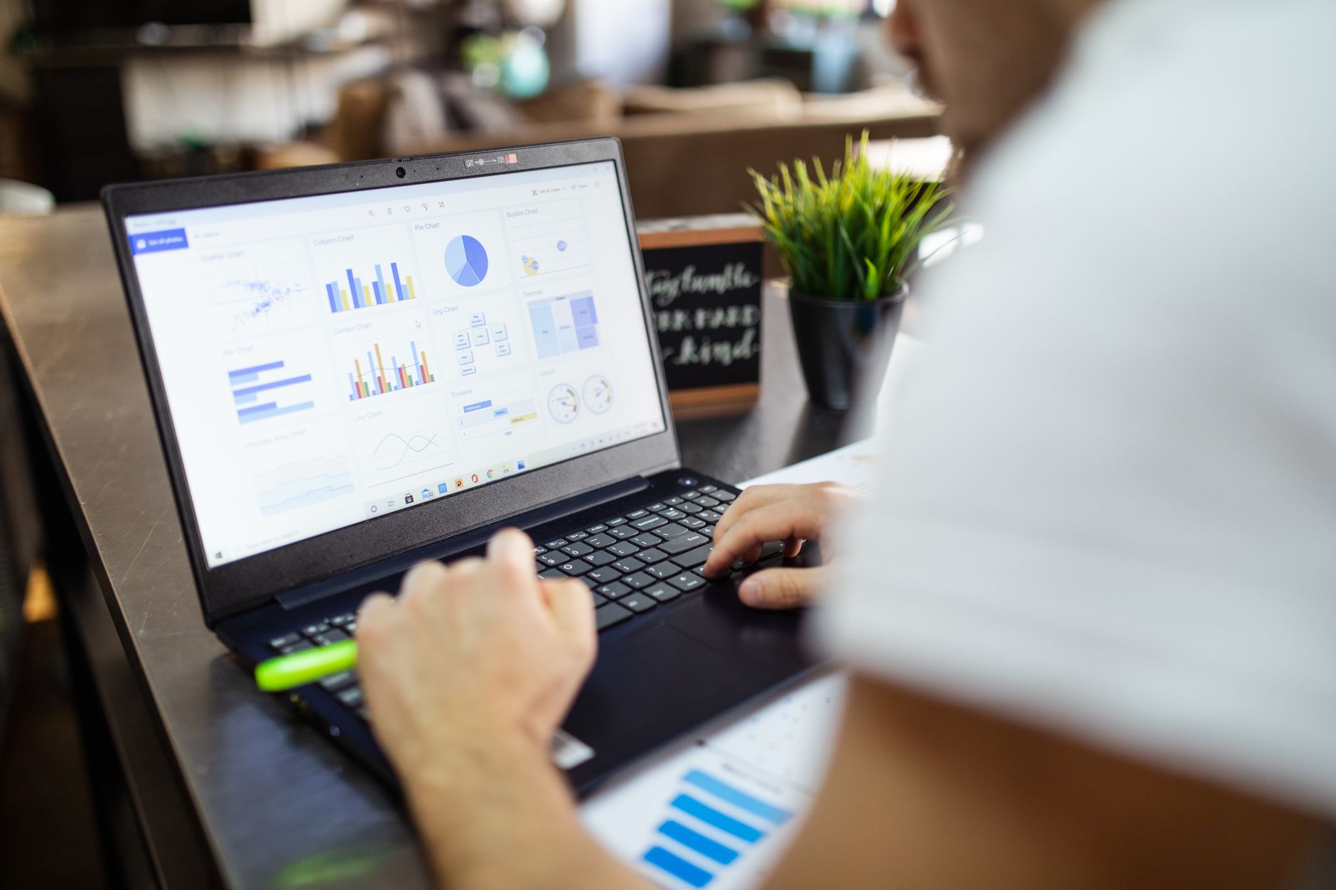 Focused business analysis with charts and graphs on a laptop in a modern office setting — UPI Study