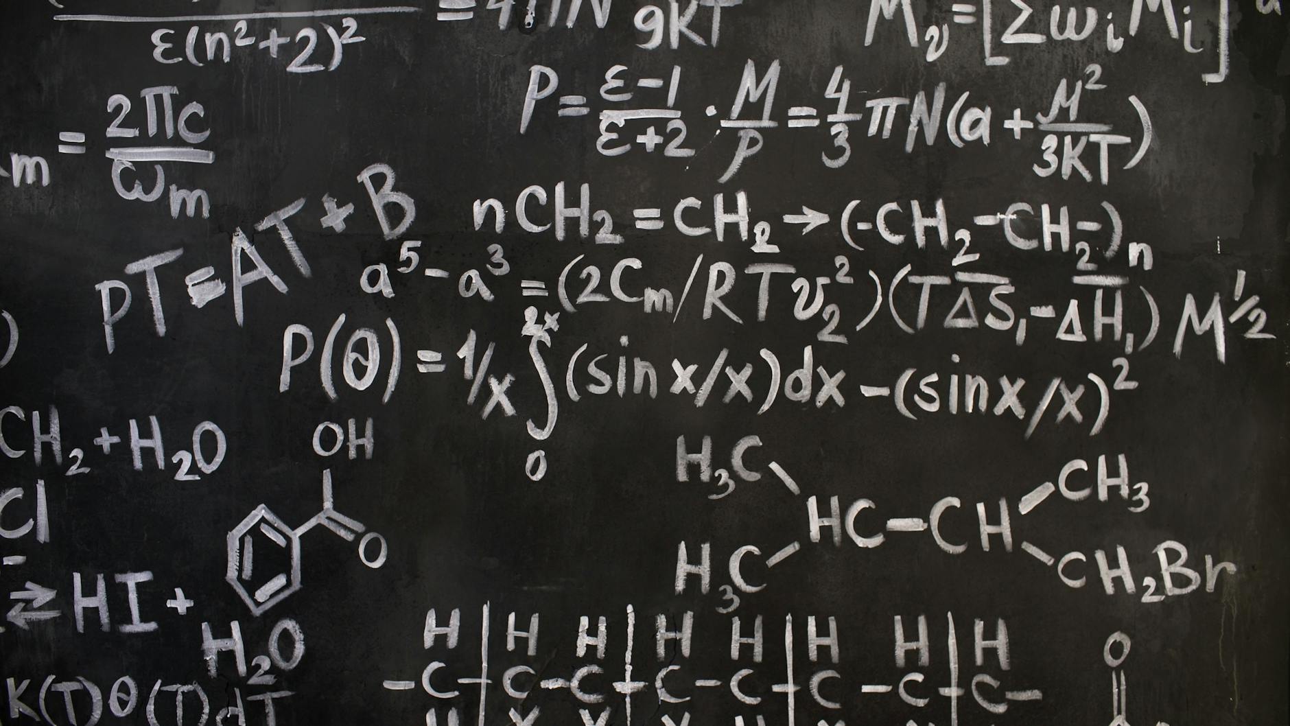 A close-up view of complex mathematical and chemical formulas on a blackboard — UPI Study