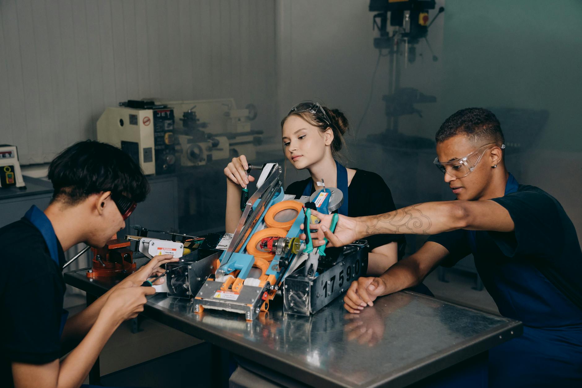 Students engaged in assembling a robotics project in an educational lab setting — UPI Study