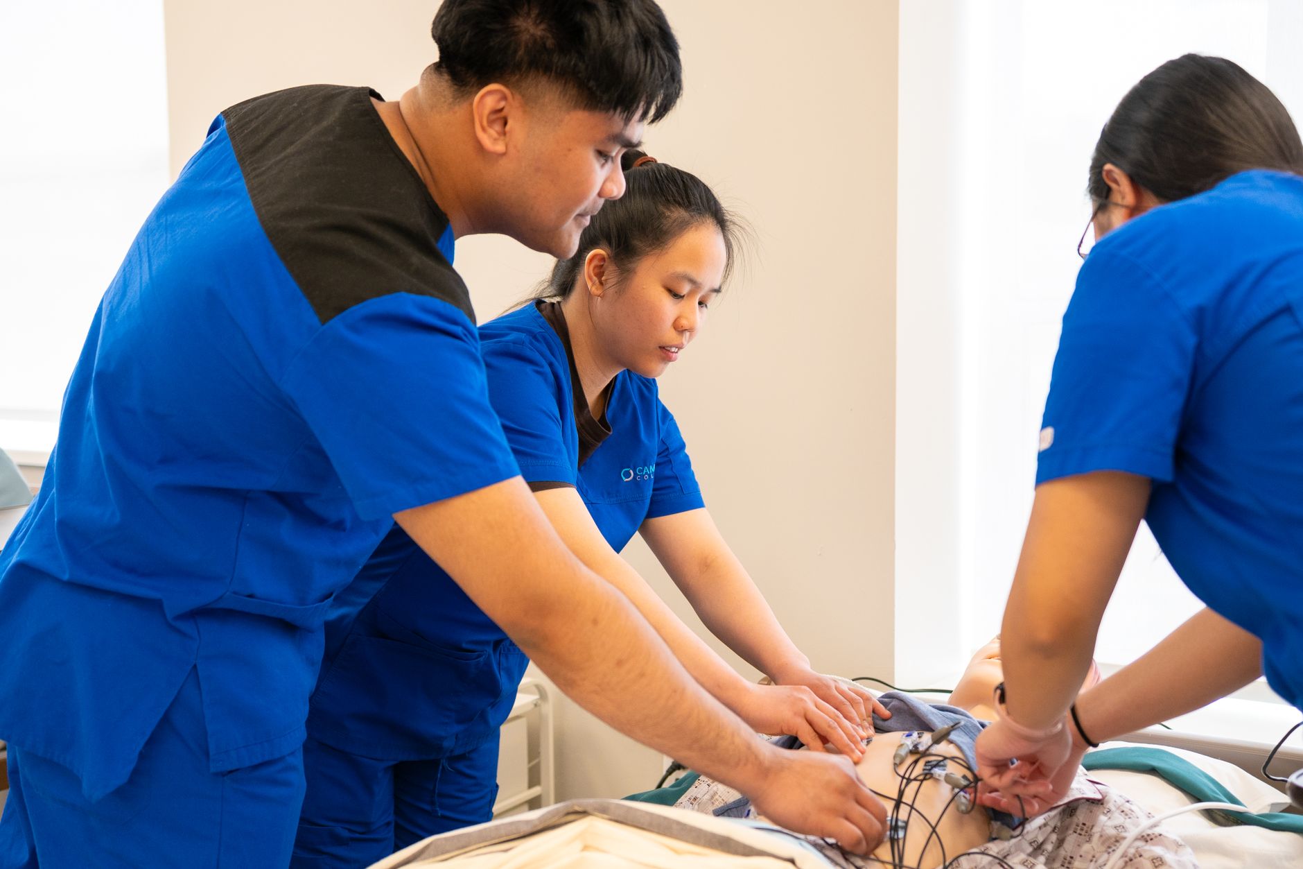 Group of nursing students conducting a medical procedure in a training room — UPI Study