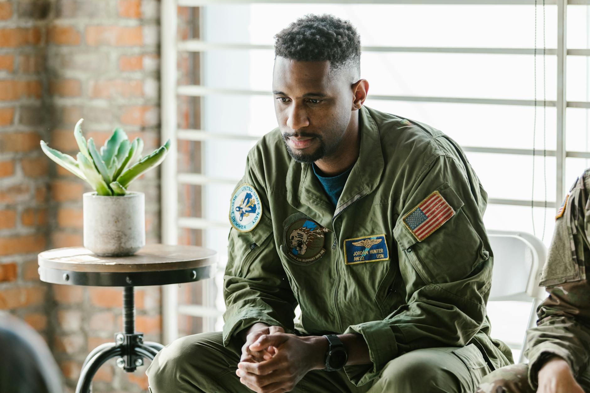 Thoughtful military veteran in uniform listening intently indoors — UPI Study