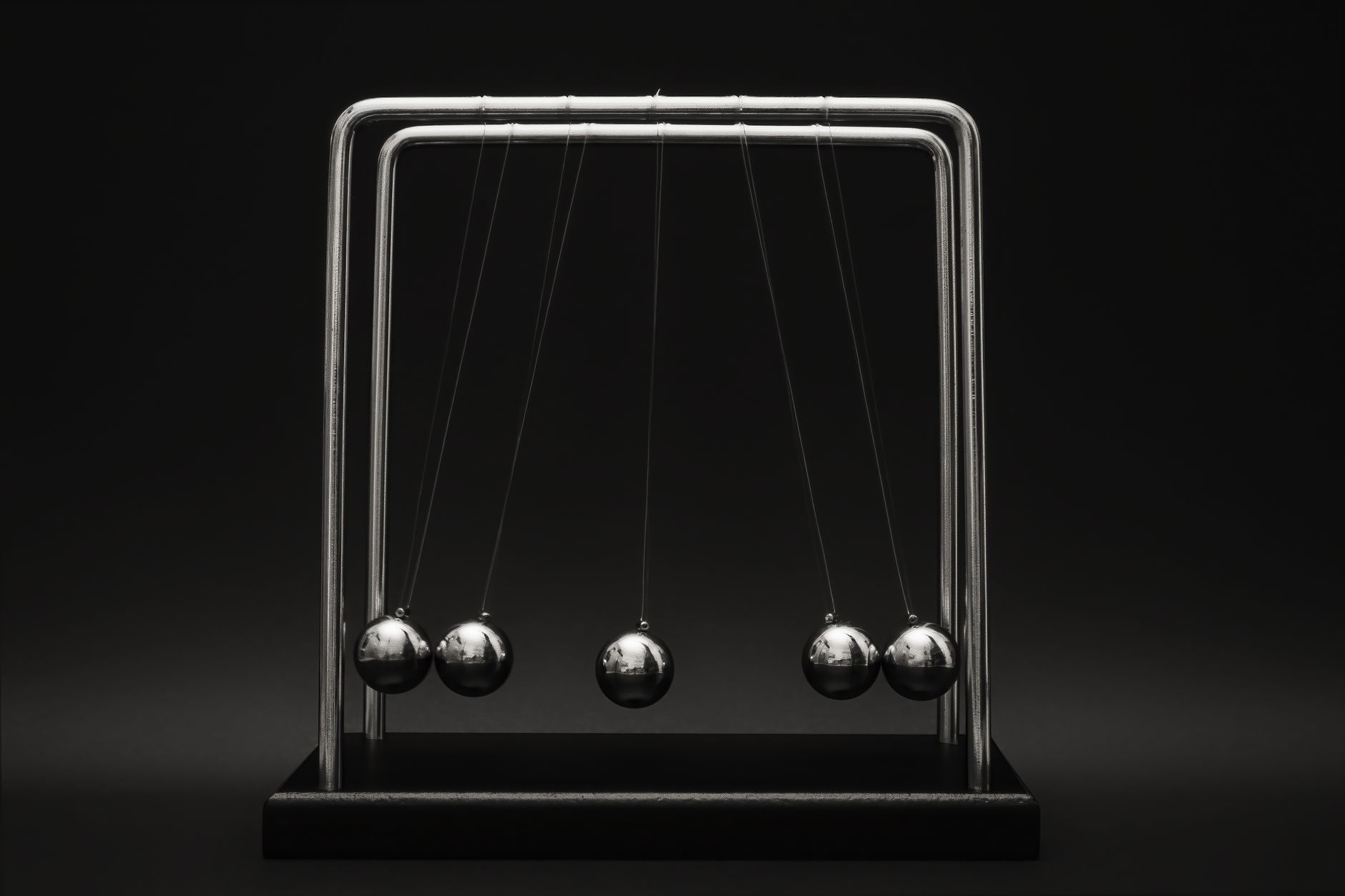 Newton's cradle for physics principles and motion study on a dark background — UPI Study