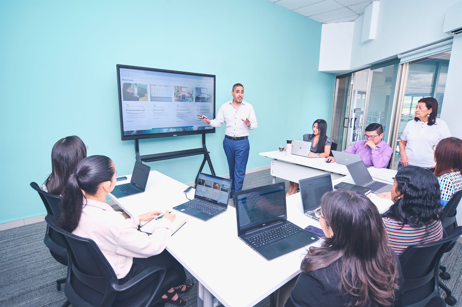 Team engaged in a presentation at a modern office using digital technology — UPI Study