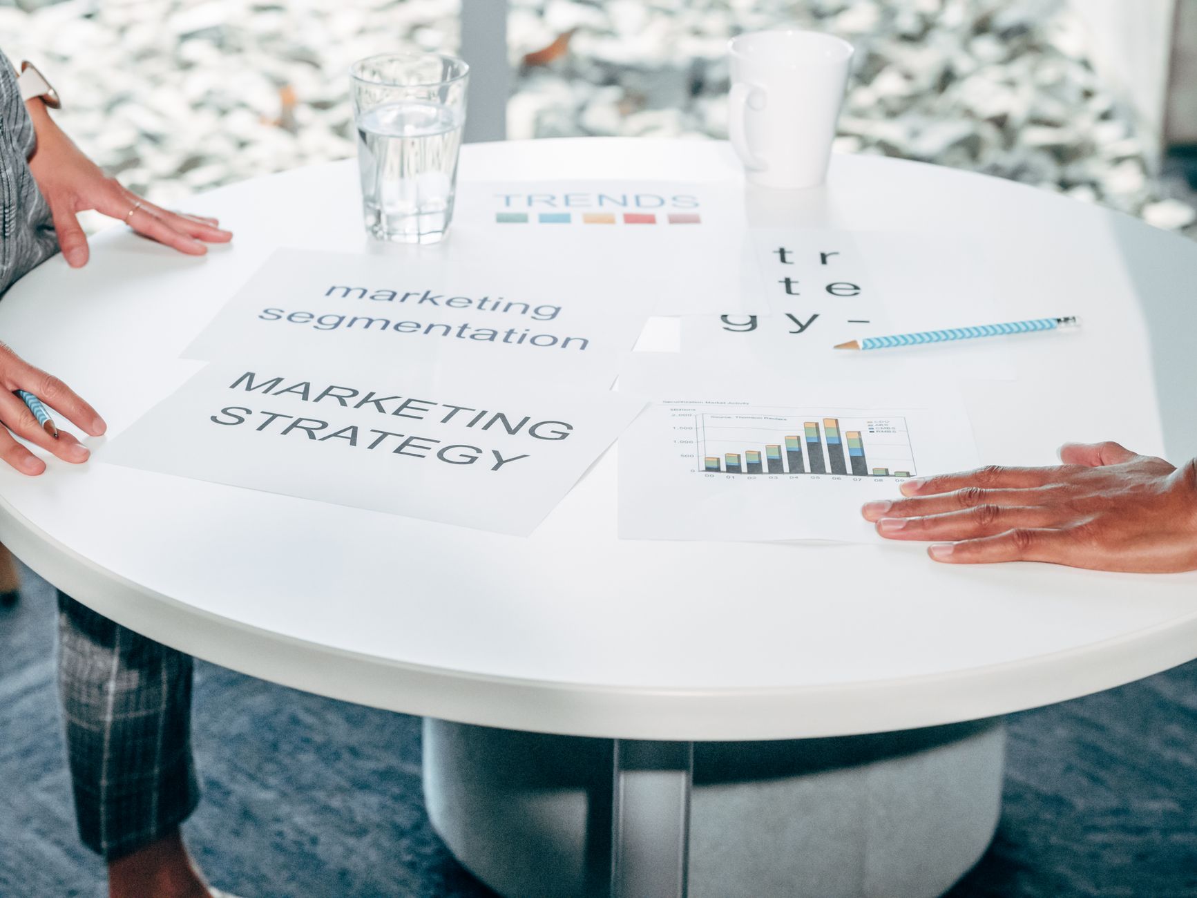 Two professionals collaborate on marketing strategy and segmentation at a round table — UPI Study