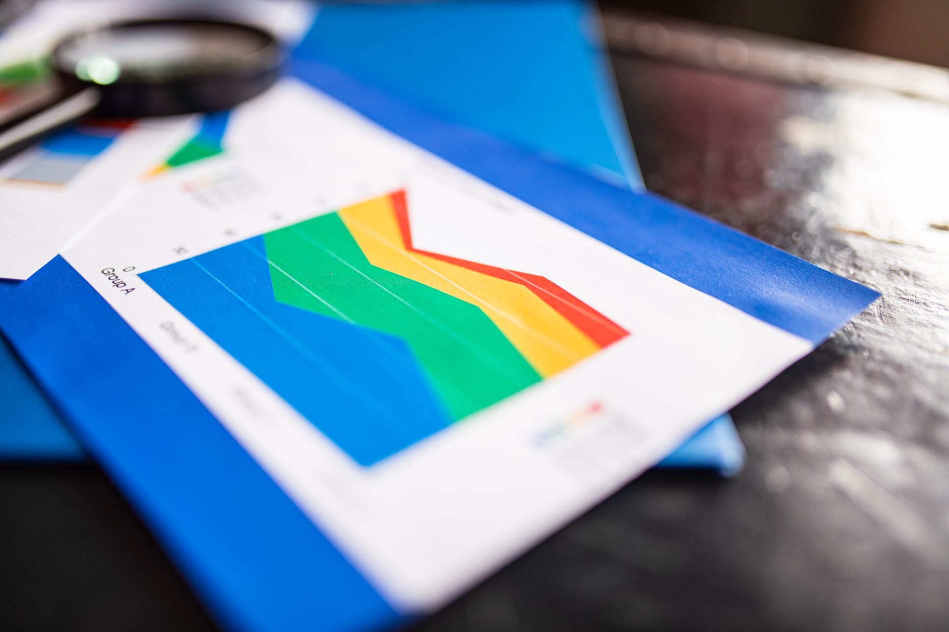 Close-up of a colorful business chart placed on a table with documents highlighting trends — UPI Study