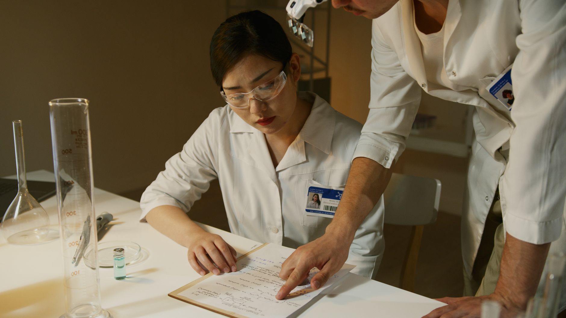 Researchers in lab coats analyzing experimental notes during a scientific study — UPI Study