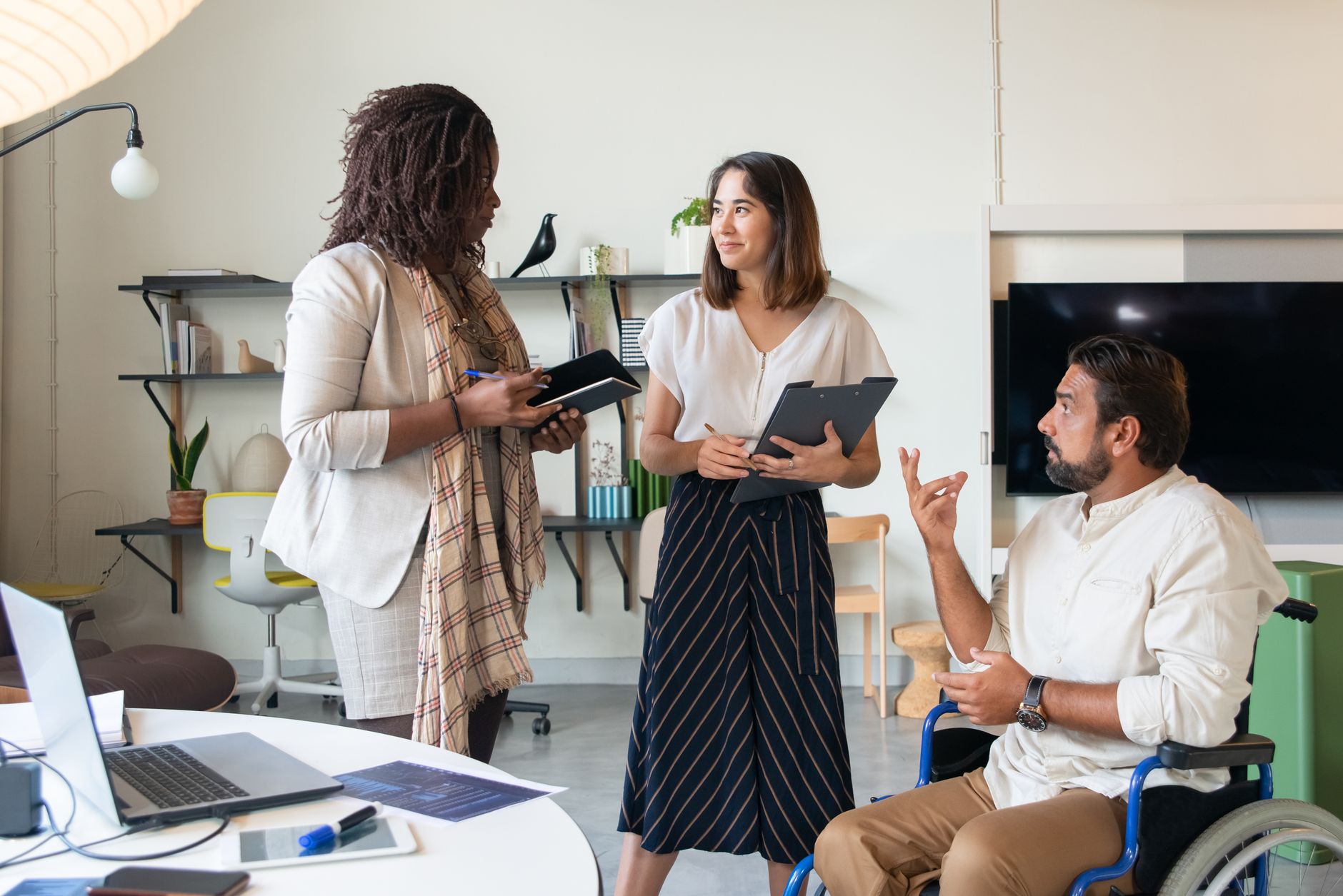 A diverse team collaborating on a project indoors, promoting inclusiveness and teamwork — UPI Study