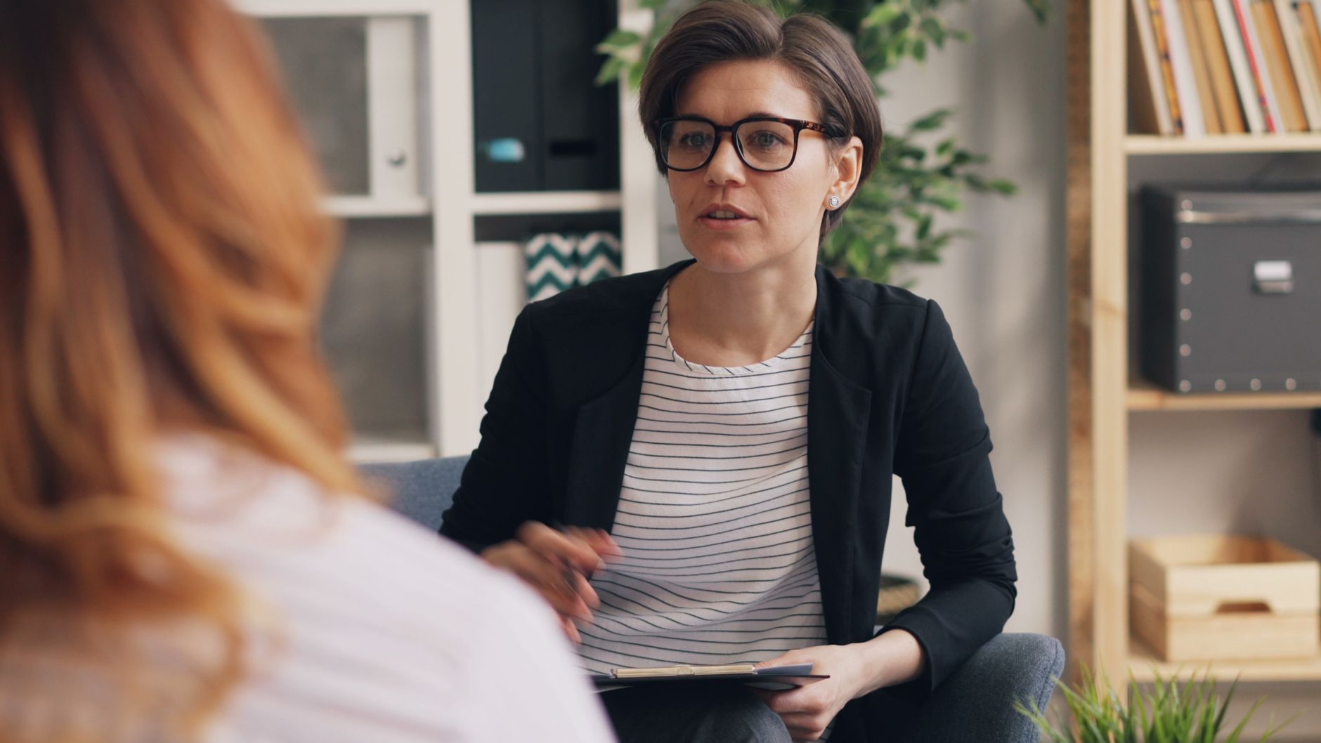 A professional therapist in a modern office setting engaged in a discussion with a client — UPI Study