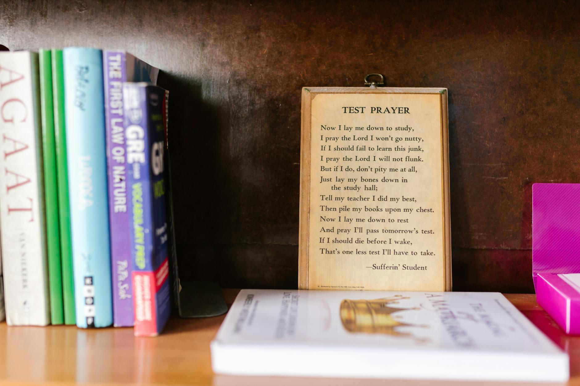 Cozy bookshelf featuring a humorous test prayer among colorful educational books — UPI Study