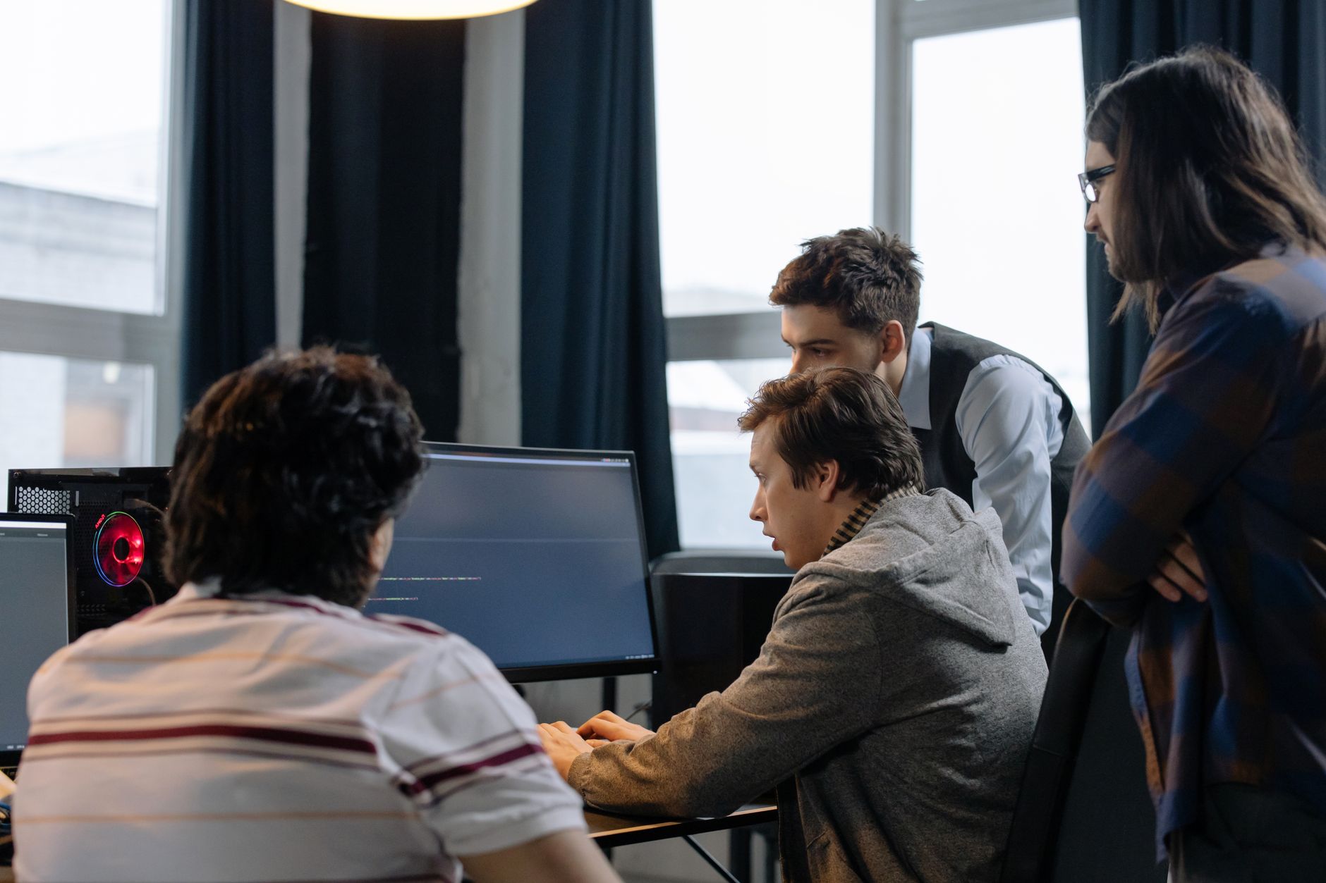 Group of developers working together on a computer programming project indoors — UPI Study