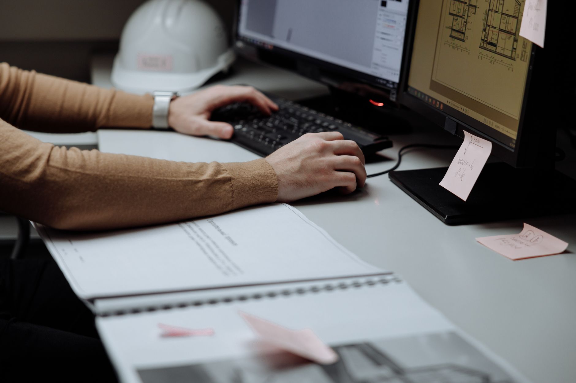 Architect focused on digital design at dual monitors in a modern workspace — UPI Study
