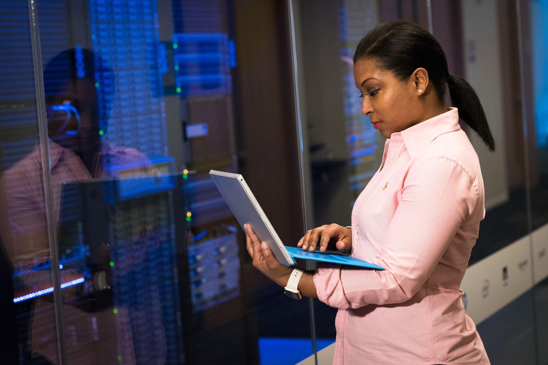 A focused software engineer working on a laptop in a server room, reflecting dedication in tech — UPI Study