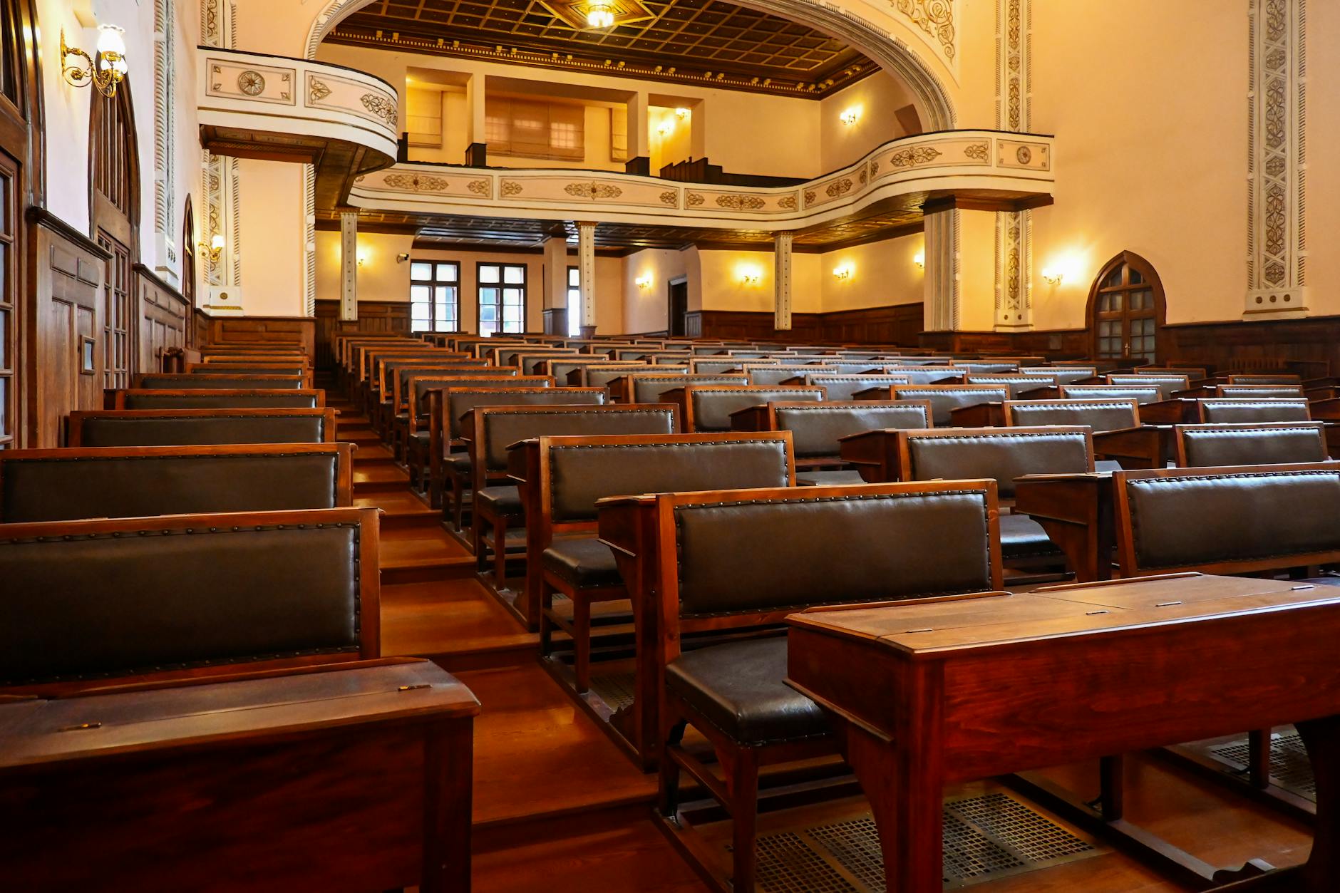 A historic lecture hall featuring wooden benches and classic architectural details, ideal for educational settings — UPI Study