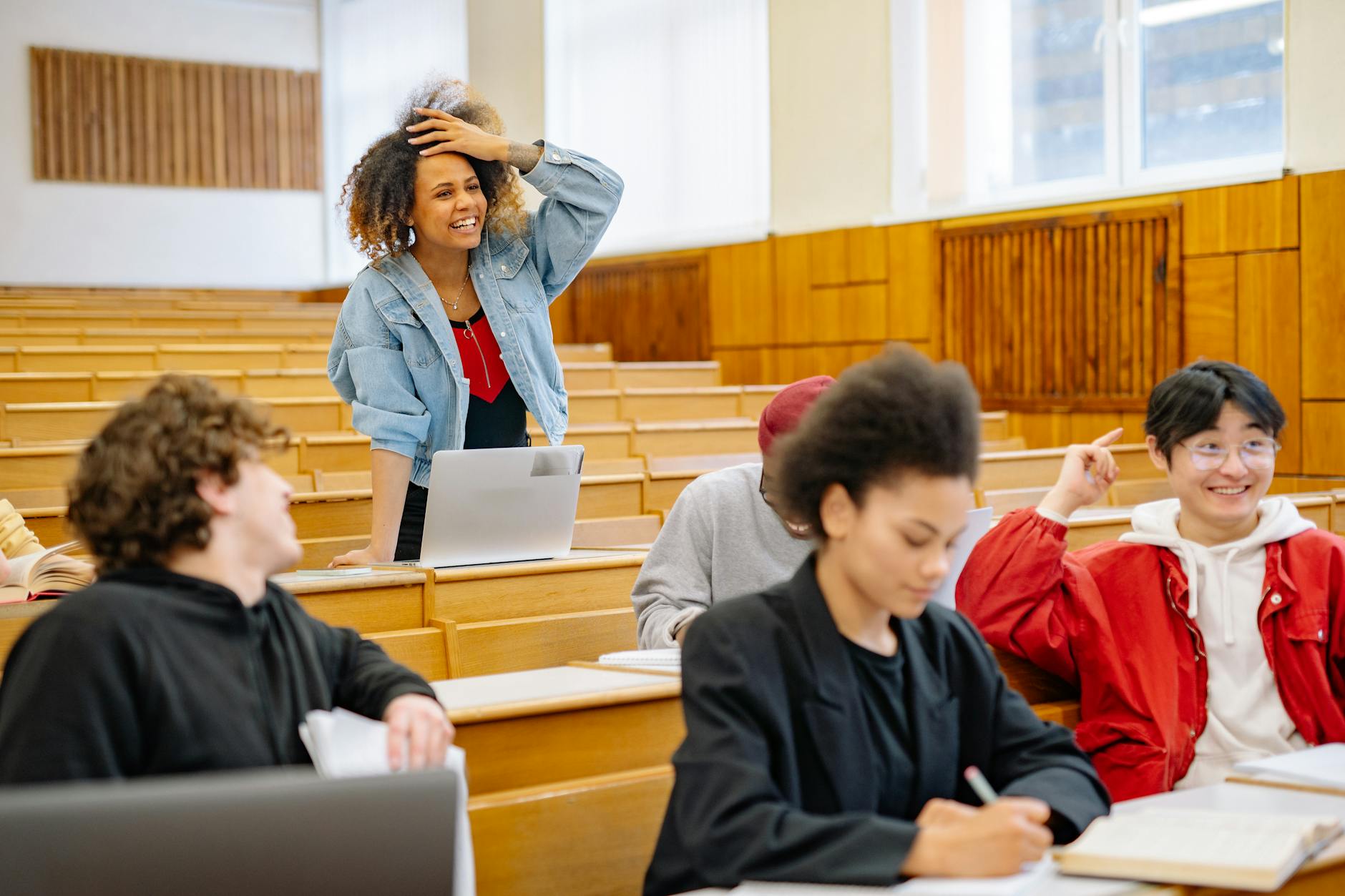Students in a university lecture hall interacting and studying together — UPI Study