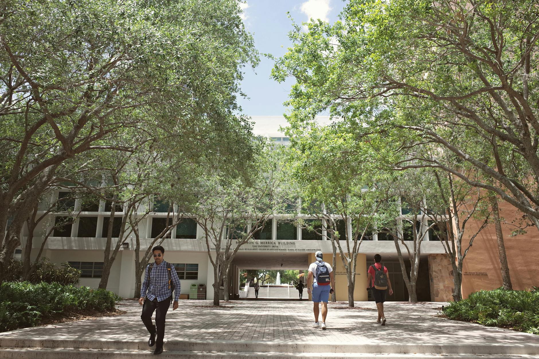 Students walking through a sunlit university campus in Coral Gables, Florida — UPI Study