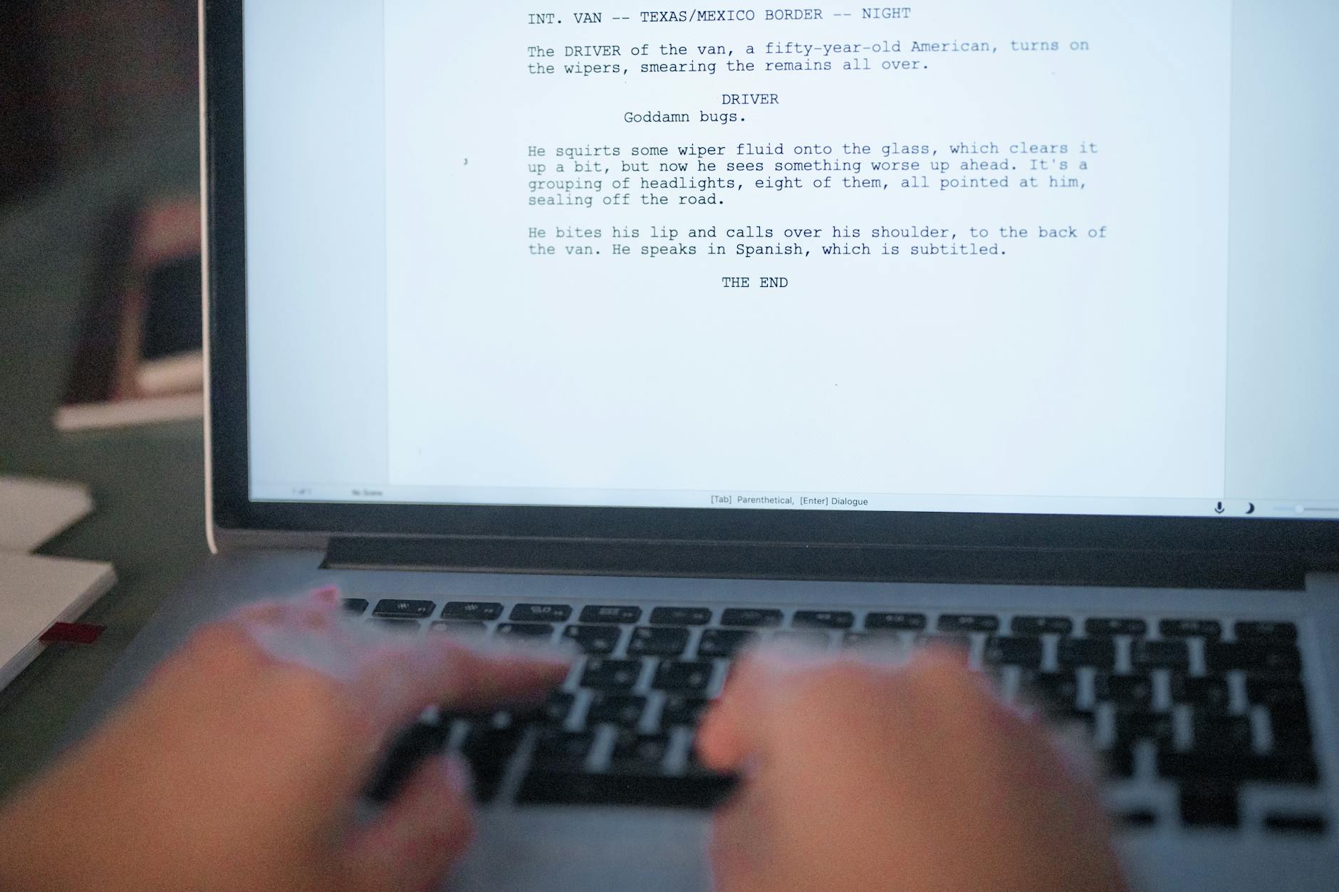 A close-up shot of hands typing a film script on a laptop, focusing on creativity and screenplay writing — UPI Study